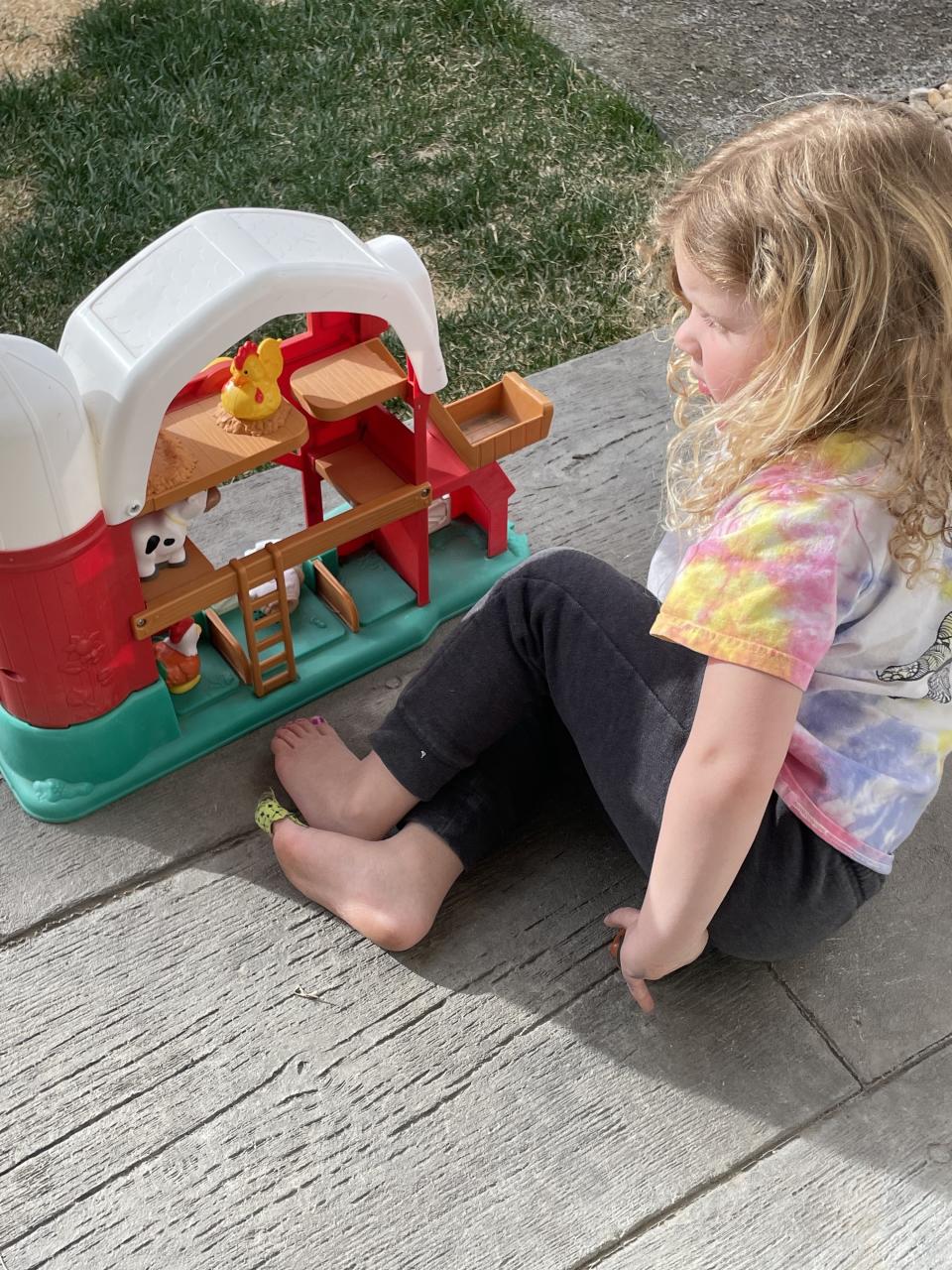 the author's daughter playing outside