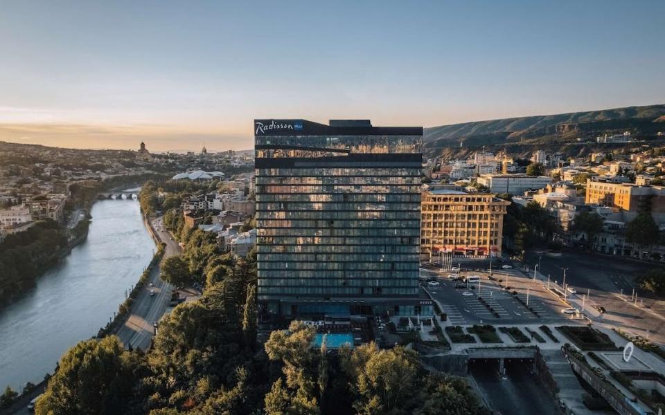 The Radisson Blu Iveria Hotel overlooks the river and the mountains