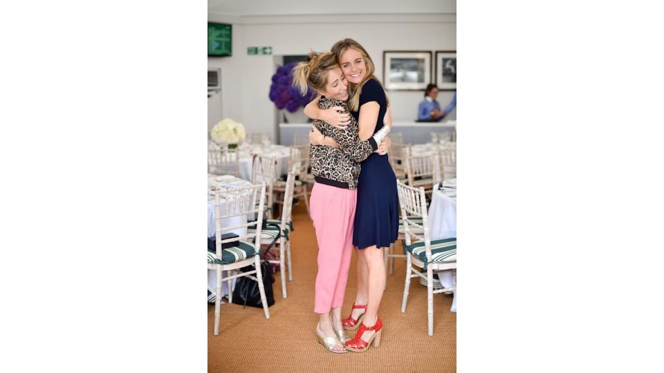 two woman cuddling in colourful clothing