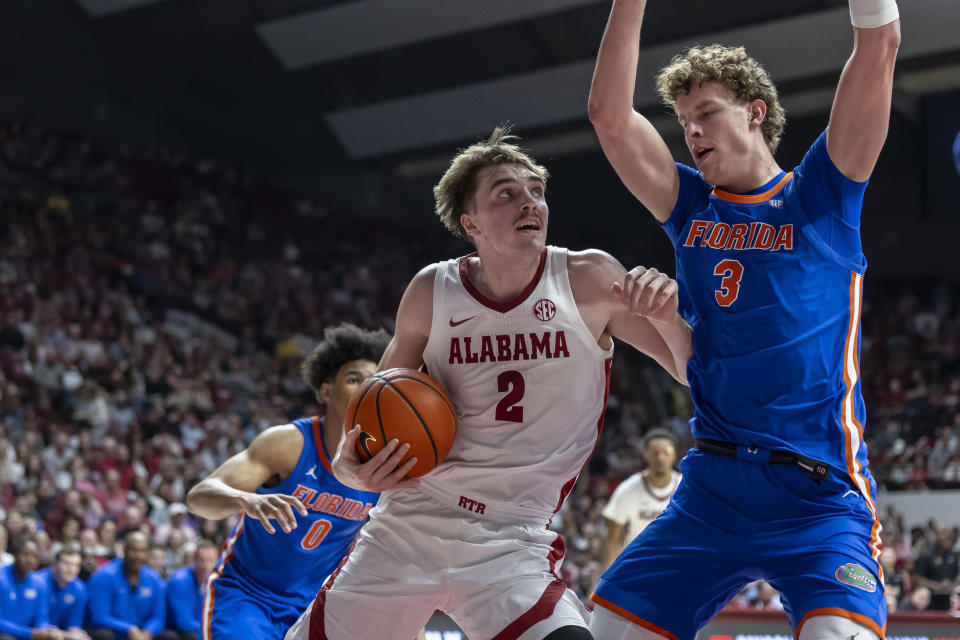 Alabama forward Grant Nelson (2) drives against Florida center Micah Handlogten (3) during the first half of an NCAA college basketball game Wednesday, Feb. 21, 2024, in Tuscaloosa, Ala. (AP Photo/Vasha Hunt)