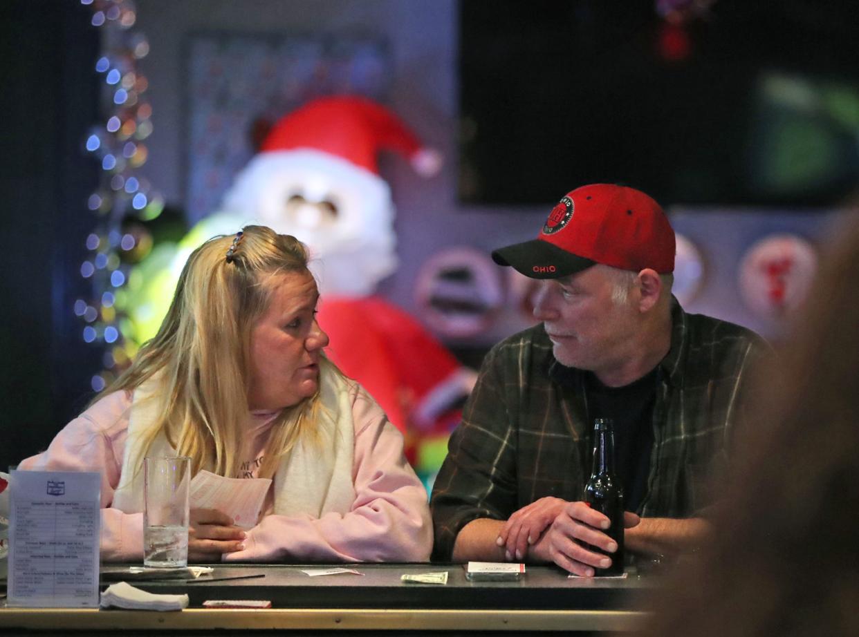 Patrons Doreen Vernotzy and Rusty Shover chat at The President's Lounge in Akron, which has transformed into The Reindeer Room for the holiday season.