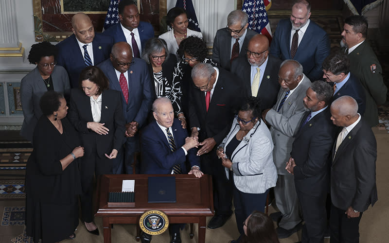 President Biden, applauded by members of the Till family and members of Congress, finishes signing a proclamation to establish the Emmett Till and Mamie Till-Mobley National Monument