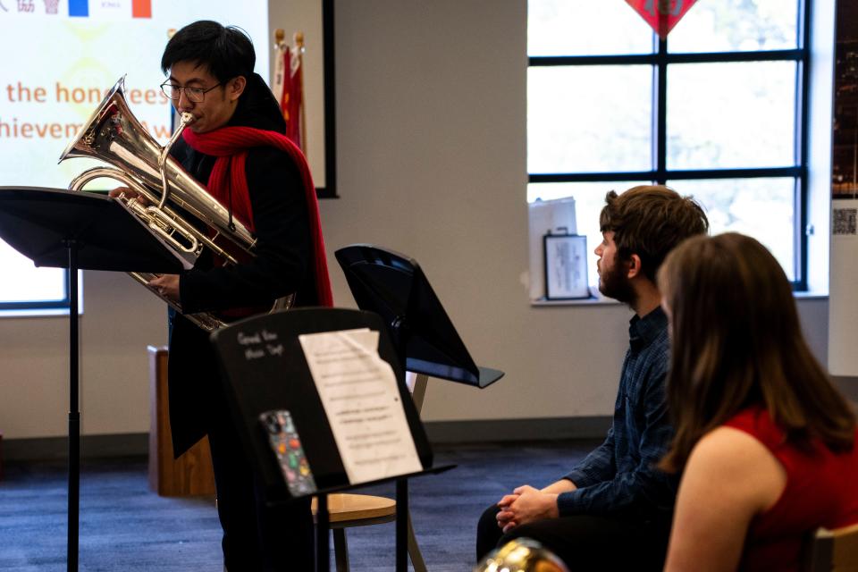 Grinnell College student Kevin Qiu performs a tuba solo as trio-mates Alex Sidler and Ella Reed look on during a Chinese New Year Celebration hosted by the Chinese Association of Iowa at Grand View University on Saturday, Feb. 10, 2024, in Des Moines.