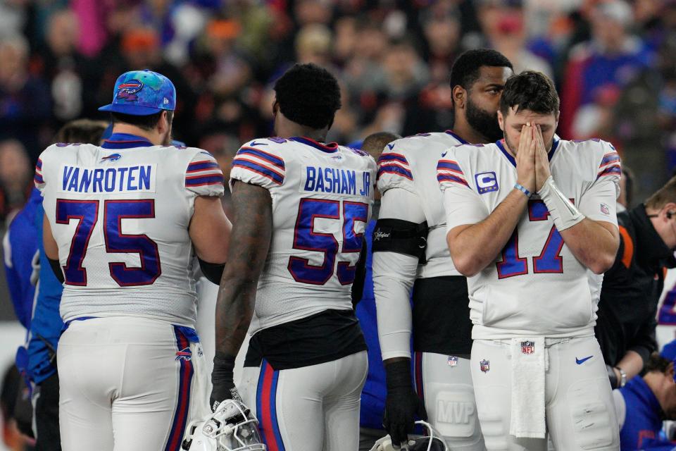 Buffalo Bills quarterback Josh Allen (17) pauses as Damar Hamlin is examined during the first half of an NFL football game against the Cincinnati Bengals, Monday, Jan. 2, 2023, in Cincinnati. (AP Photo/Jeff Dean)