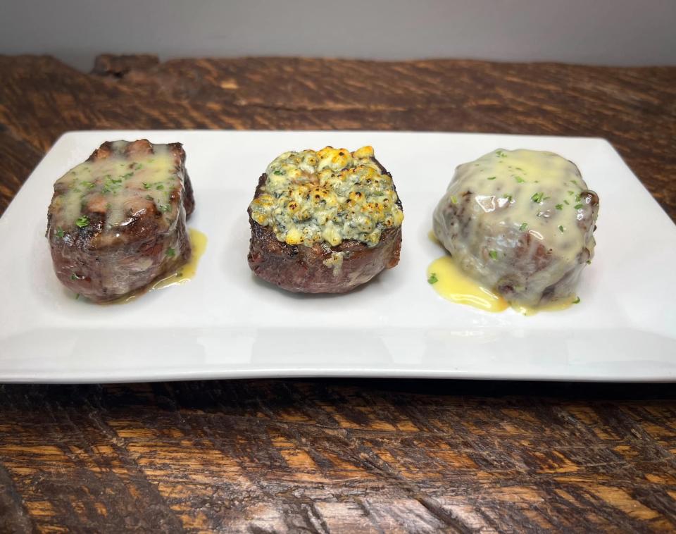 The filet trio at Filet Steakhouse comes with de Burgo sauce, blue cheese crumbles, and béarnaise sauce.