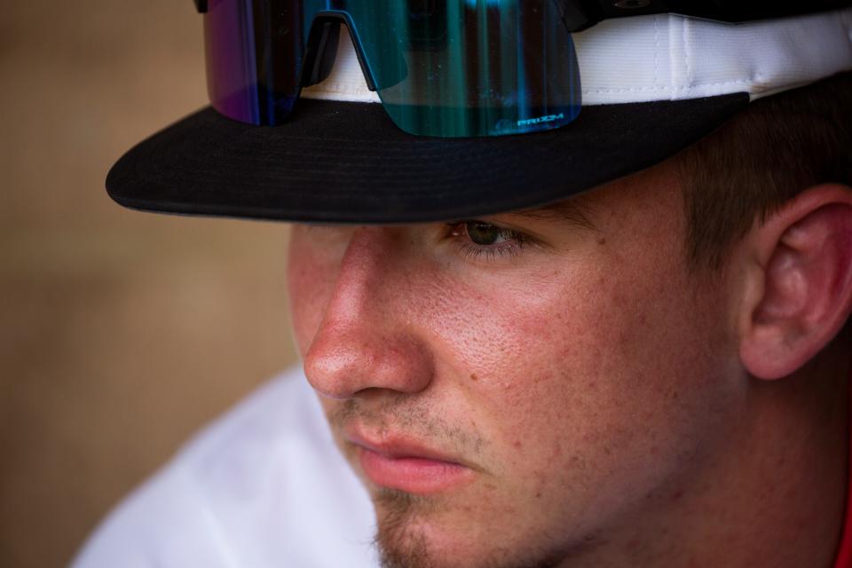 Jacob Miller sits on the bench inside of the dugout before he takes to the pitchers mound to pitch against Cardington in a Division III baseball game at Liberty Union High School in Baltimore, Ohio on May 11, 2022. Jacob has been scouted for his pitching talents by Major League Baseball scouts and early projections show he will be drafted in the first round of the Major League Baseball Draft in July 2022.