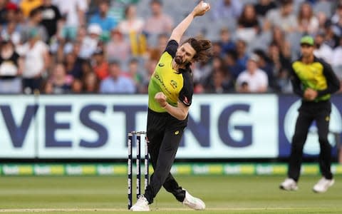 Australia's Kane Richardson (L) bowls during the Twenty20 International Tri-Series cricket match between England and Australia at the MCG  - Credit: CON CHRONIS/AFP