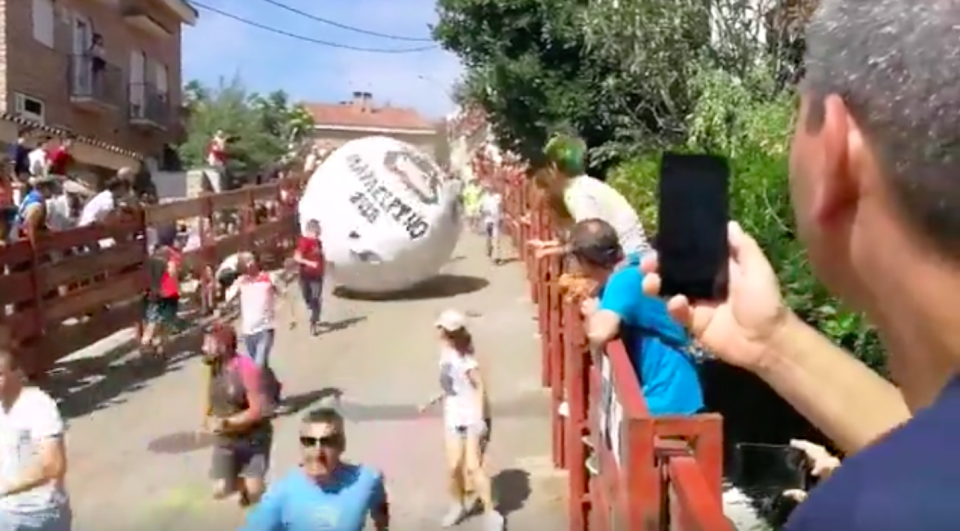 Participants in the festival run away from a ball that weighed 250kg this year. Source: Storyful