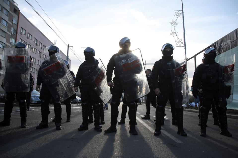 Serbian police officers deployed to block the demonstrators from reaching the bridge during a protest in Belgrade, Serbia, Saturday, Nov. 27, 2021. Skirmishes on Saturday erupted in Serbia between police and anti-government demonstrators who blocked roads and bridges in the Balkan country in protest against new laws they say favor interests of foreign investors devastating the environment. (AP Photo/Milos Miskov)