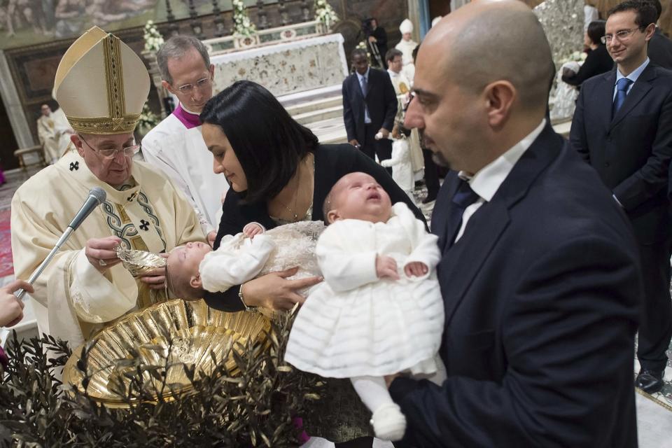 Pope Francis baptises a newborn during a solemn mass in the Sistine Chapel at the Vatican January 11, 2015. Pope Francis baptized 33 infants in the Sistine Chapel on Sunday and told the mothers to feel free to breastfeed them if they cried or were hungry. REUTERS/Osservatore Romano (VATICAN - Tags: SOCIETY RELIGION) ATTENTION EDITORS - THIS PICTURE WAS PROVIDED BY A THIRD PARTY. REUTERS IS UNABLE TO INDEPENDENTLY VERIFY THE AUTHENTICITY, CONTENT, LOCATION OR DATE OF THIS IMAGE. NO SALES. NO ARCHIVES. FOR EDITORIAL USE ONLY. NOT FOR SALE FOR MARKETING OR ADVERTISING CAMPAIGNS. THIS PICTURE IS DISTRIBUTED EXACTLY AS RECEIVED BY REUTERS, AS A SERVICE TO CLIENTS