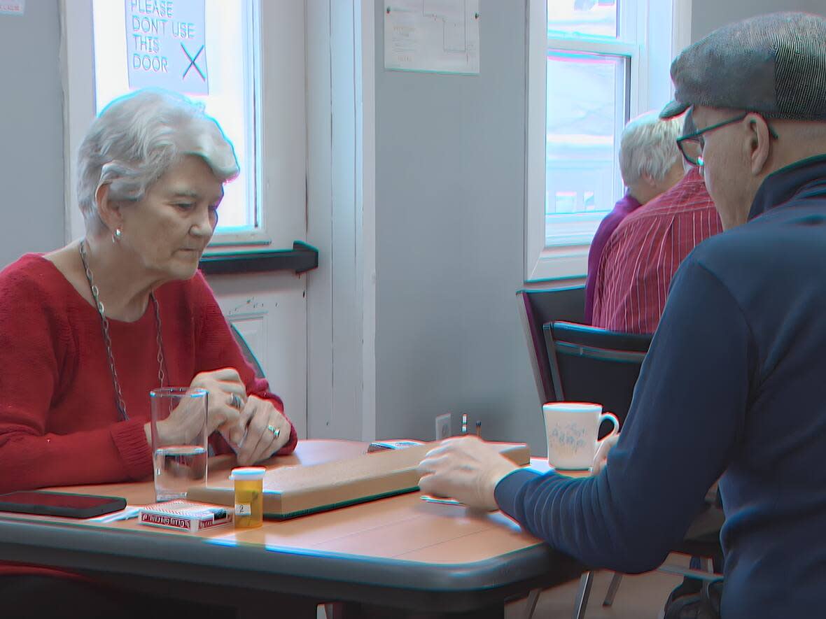 Seniors play cribbage before lunch at Spencer House in Halifax's south end in early March. (Robert Short/CBC - image credit)