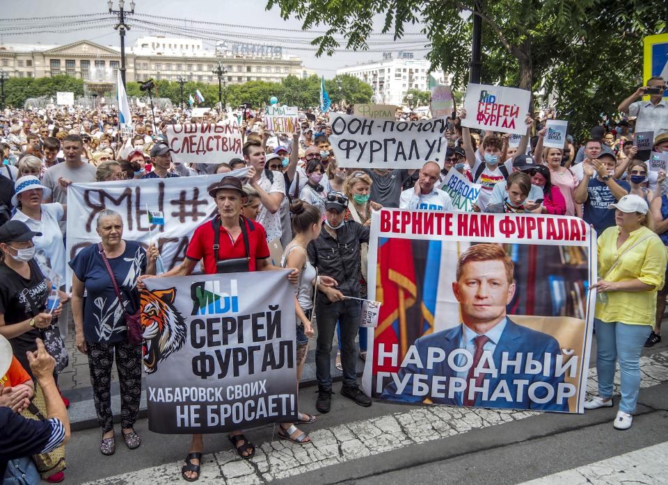 People hold posters reading "Freedom for Sergei Furgal, I am, we are Sergei Furgal," "Give us Furgal back", "Call Furgal home" during an unsanctioned protest in support of Sergei Furgal, the governor of the Khabarovsk region, in Khabarovsk, 6100 kilometers (3800 miles) east of Moscow, Russia, Saturday, July 18, 2020. Tens of thousands of people in the Russian Far East city of Khabarovsk took to the streets on Saturday, protesting the arrest of the region's governor on charges of involvement in multiple murders. Local media estimated the rally in the city attracted from 15,000 to 50,000 people. (AP Photo/Igor Volkov)