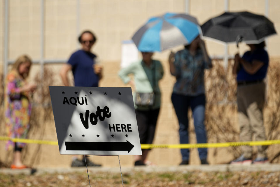 Voters use umbrellas to beat the heat as they wait in line at a polling site, Tuesday, March 5, 2024, in San Antonio. (AP Photo/Eric Gay)