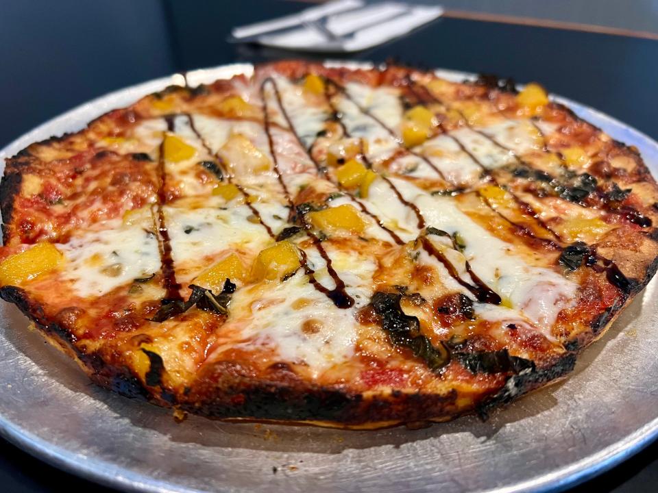 The Miss Peaches pizza is a special menu item at Alumni Sports Cafe in Pembroke. It features sliced peaches, fresh basil, mozzarella and balsamic vinegar. The name comes from the American pit bull rescue of Barstool Sports founder Dave Portnoy.