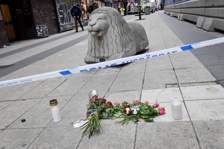 STOCKHOLM 2017-04-08 People laying flowers near the crime scene in central Stockholm the morning after a hijacked beer truck plowed into pedestrians on Drottninggatan and crashed into Ahlens department store on Friday, killing four people, injuring 15 others. TT News Agency/Jonas Ekstromer/via REUTERS