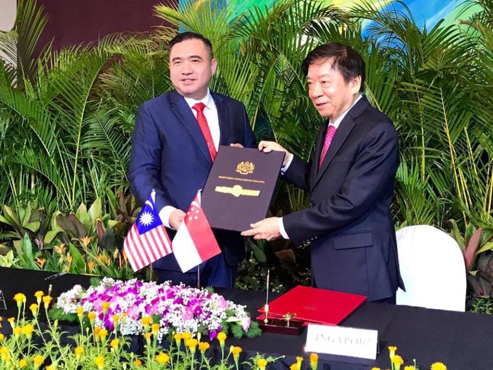 Transport Minister Anthony Loke and his Singapore counterpart Khaw Boon Wan are seen during the signing of the supplementary agreement for the RTS suspension between the two countries at the PSA Building in Singapore May 21, 2019. — Picture by Ben Tan