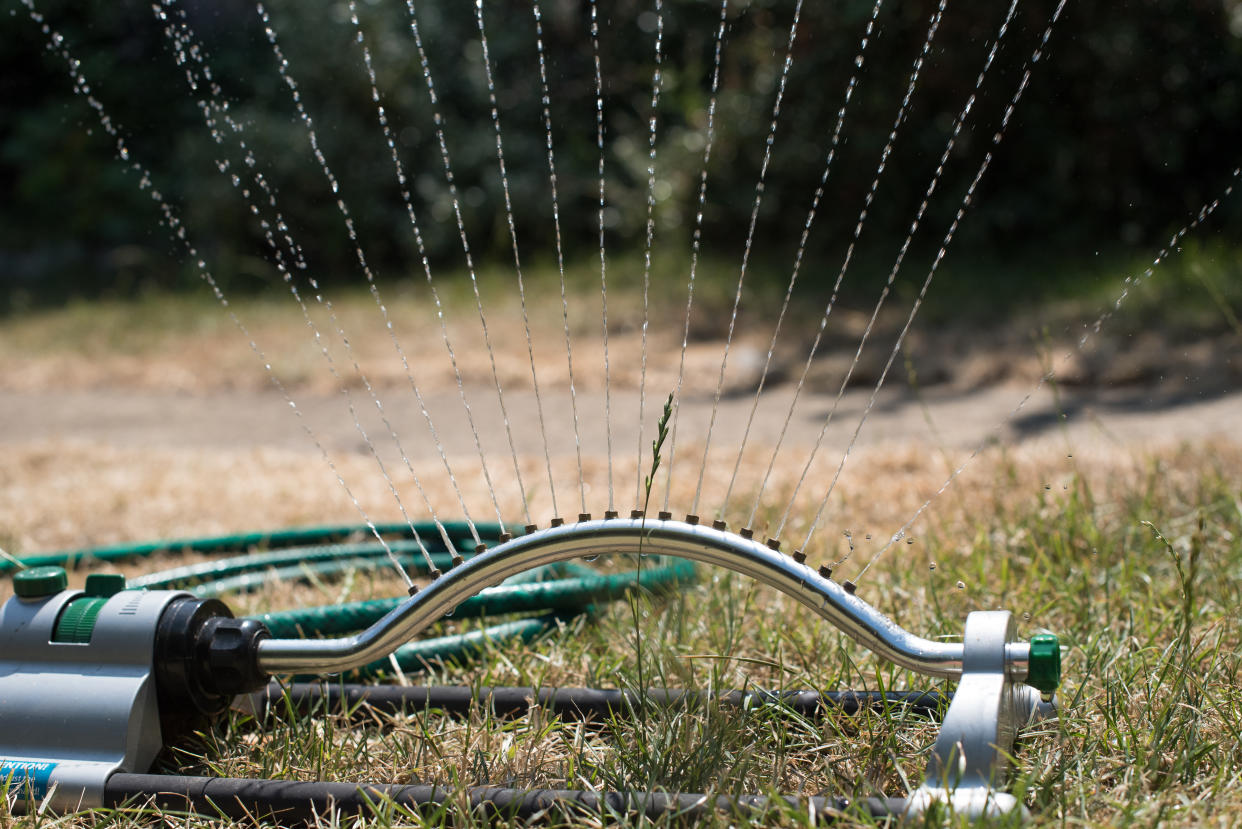 LEIGH ON SEA, ENGLAND - JULY 24: Water sprays from a sprinkler in a garden on July 24, 2018 in Leigh On Sea, England. Seven million residents in the north west of England are currently facing a hosepipe ban due to the heatwave and water companies in other areas of the UK are continuing to urge customers to use water wisely in the ongoing hot, dry conditions. (Photo by John Keeble/Getty Images)