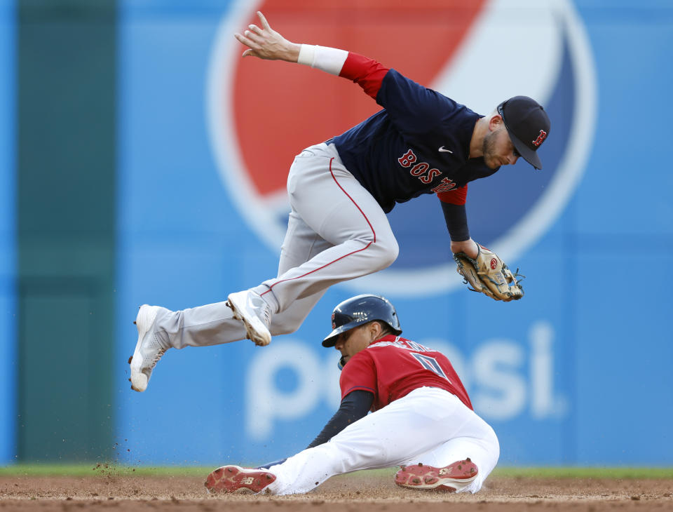 Cleveland Guardians' Andres Gimenez steals second base below Boston Red Sox second baseman Trevor Story during the second inning of a baseball game, Friday, June 24, 2022, in Cleveland. (AP Photo/Ron Schwane)