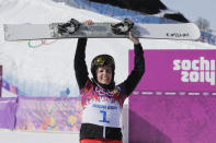 FILE - Women's snowboard parallel giant slalom gold medalist Switzerland's Patrizia Kummer celebrates at the Rosa Khutor Extreme Park, at the 2014 Winter Olympics, Wednesday, Feb. 19, 2014, in Krasnaya Polyana, Russia. Three weeks alone in a hotel room is hardly an ideal setting for a snowboarder preparing for the Olympics. Kummer, a Swiss competitor who won a gold medal at the 2014 Sochi Olympics, is unvaccinated against the coronavirus by choice, so she is spending 21 days in isolation in China before the Winter Games begin in Beijing on Feb. 4.(AP Photo/Andy Wong, File)