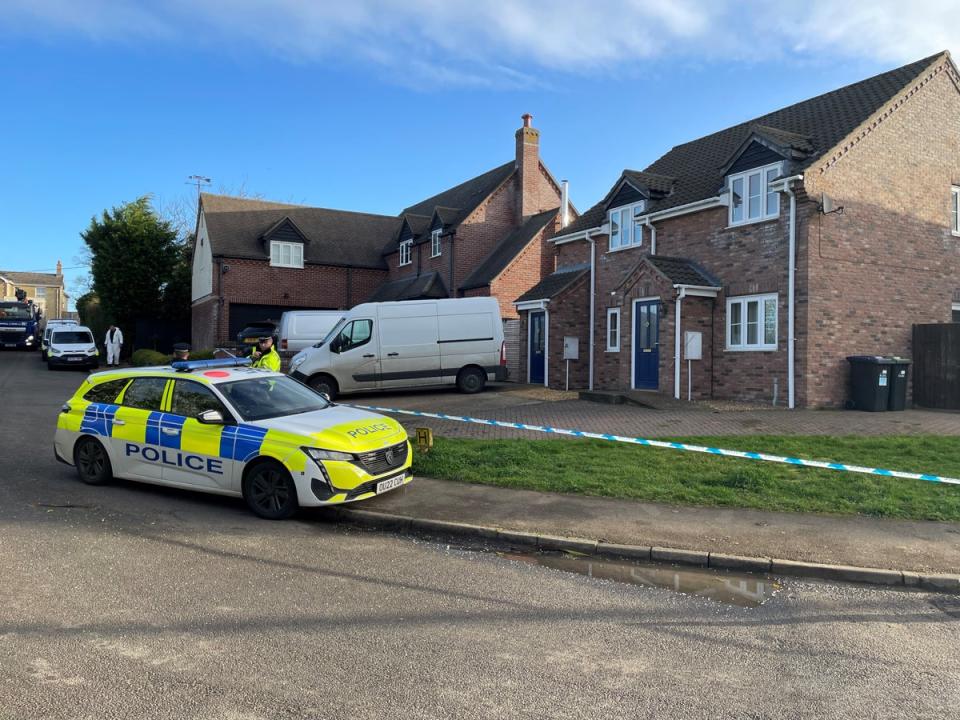 Police at the scene in The Row in Sutton, near Ely, Cambridgeshire, where police found the body of a 57-year-old man who had died from gunshot wounds (PA)