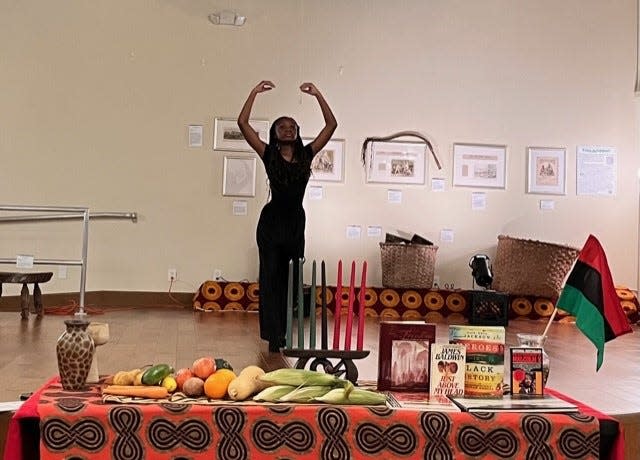 Amani Gainey, a student at Howard Bishop Middle School, performs an interpretive praise dance during a Kwanzaa ceremony held Dec. 26 at the Cotton Club Museum and Cultural Center in southeast Gainesville.
(Photo: Photo courtesy of Barbara McDade Gordon/Special to The Guardian)