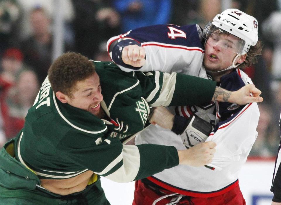 Minnesota Wild right wing Chris Stewart (7) and Columbus Blue Jackets right wing Josh Anderson (34) fight during the second period of an NHL hockey game Saturday, Dec. 31, 2016, in St. Paul, Minn. (AP Photo/Andy Clayton-King)