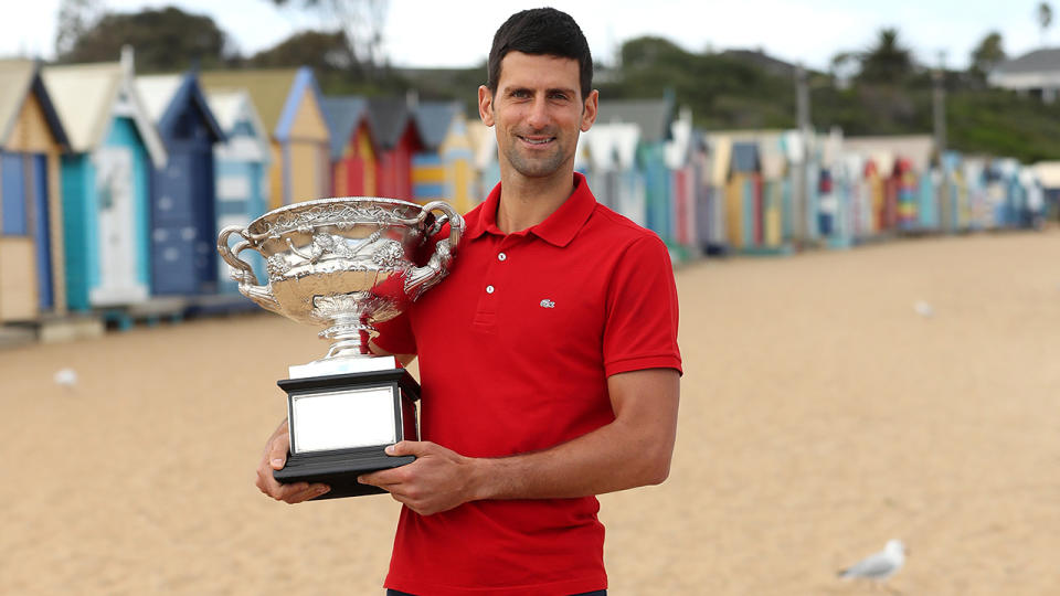Novak Djokovic poses with the Norman Brookes Challenge Cup after winning the 2021 Australian Open Men's Final. (Photo by Graham Denholm/Getty Images)