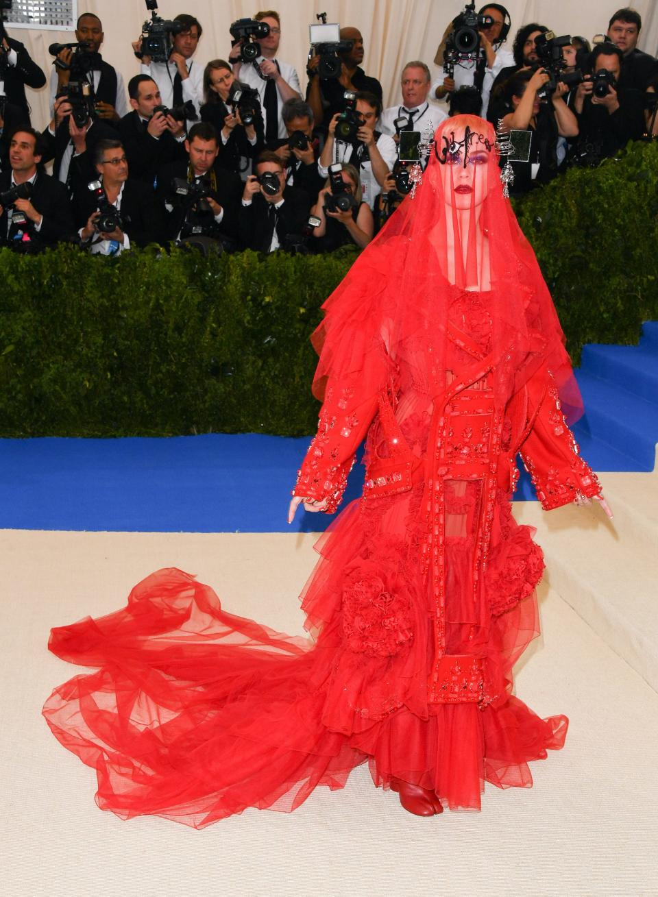 Katy Perry attends the met gala in 2017 wearing red dress with veil