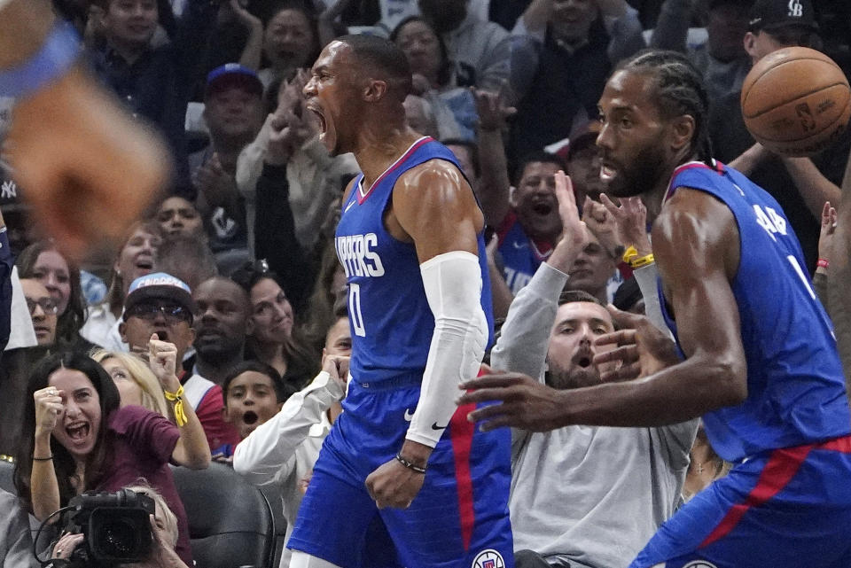 Los Angeles Clippers guard Russell Westbrook, left, celebrates after scoring as forward Kawhi Leonard looks on during the first half of an NBA basketball game against the Portland Trail Blazers Wednesday, Oct. 25, 2023, in Los Angeles. (AP Photo/Mark J. Terrill)