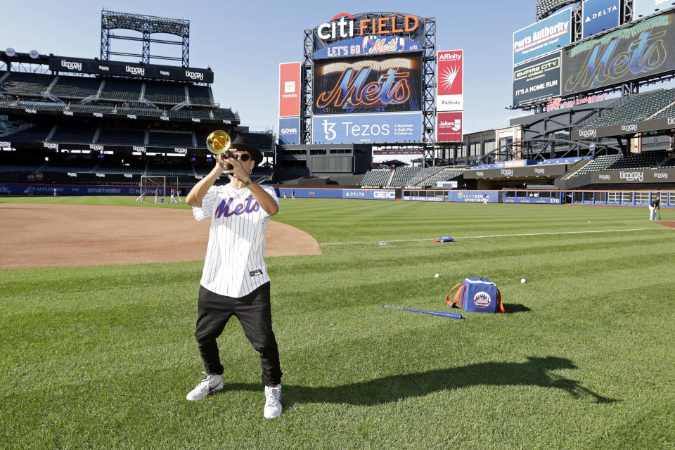 Musician Timmy Trumpet performs on the field before a baseball game between the Los Angeles Dodgers and the New York Mets on Tuesday, Aug. 30, 2022, in New York. (AP Photo/Adam Hunger)