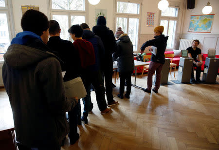 People cast their ballots in a ballot office to vote on the nuclear exit, in a school in Bern, Switzerland November 27, 2016. REUTERS/Ruben Sprich