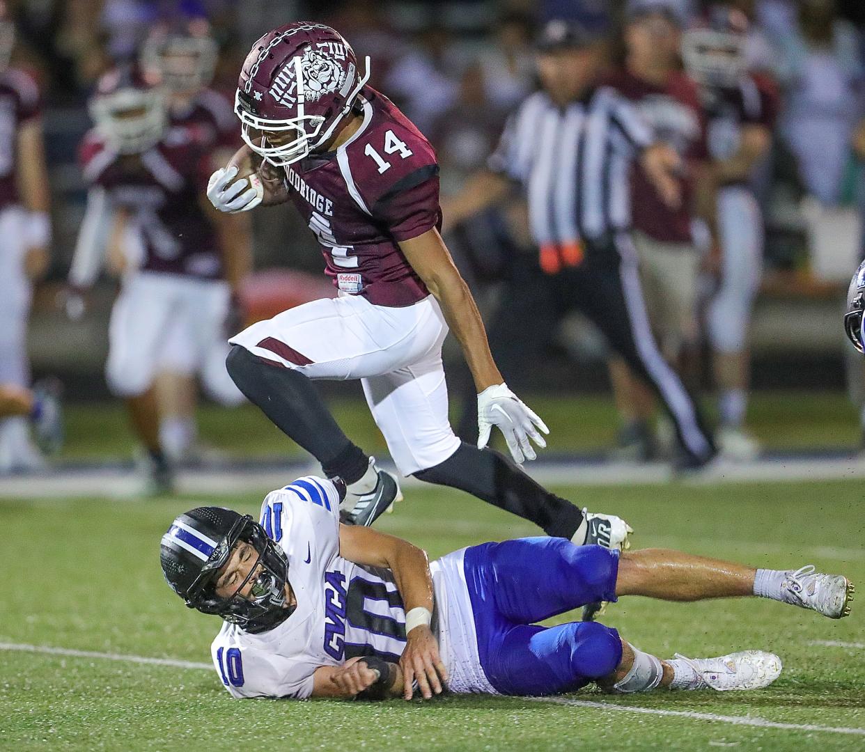 Woodridge running back Taysear Williams-CLay runs over CVCA defender Ricky Levak during a 43-yard touchdown run in the third quarter on Friday, Sept. 2, 2022 in Cuyahoga Falls.