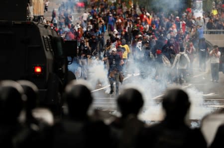 Demonstrators clash with police officers during protests after Ecuador's President Lenin Moreno's government ended four-decade-old fuel subsidies in Quito