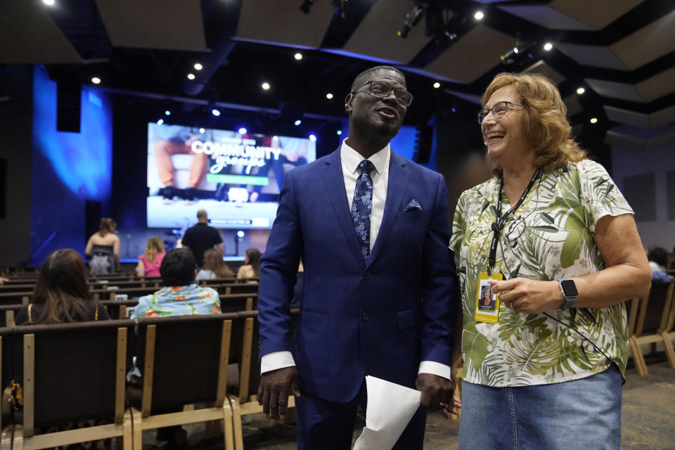 Pastor Les Robinson jokes with fellow pastor Julie Sandeen at The Sanctuary Church Sunday, May 14, 2023, in Santa Clarita, Calif. (AP Photo/Marcio Jose Sanchez)