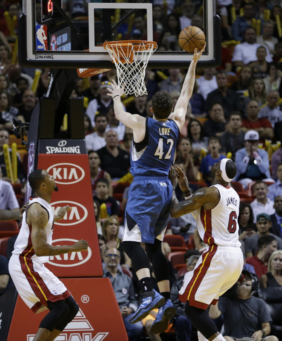 Minnesota Timberwolves forward Kevin Love (42) goes to the basket against the Miami Heat during the first half of an NBA basketball game in Miami, Friday, April 4, 2014. (AP Photo/Alan Diaz)