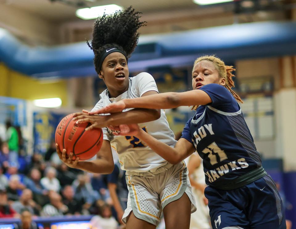 Pflugerville's Aamaria Wright, left, controls a rebound from Hendrickson's Mikalah Buckley during Saturday's 38-31 Hawks win in a showdown for first place in District 23-6A. The two teams, both ranked among the state's top 10, split their regular-season series.