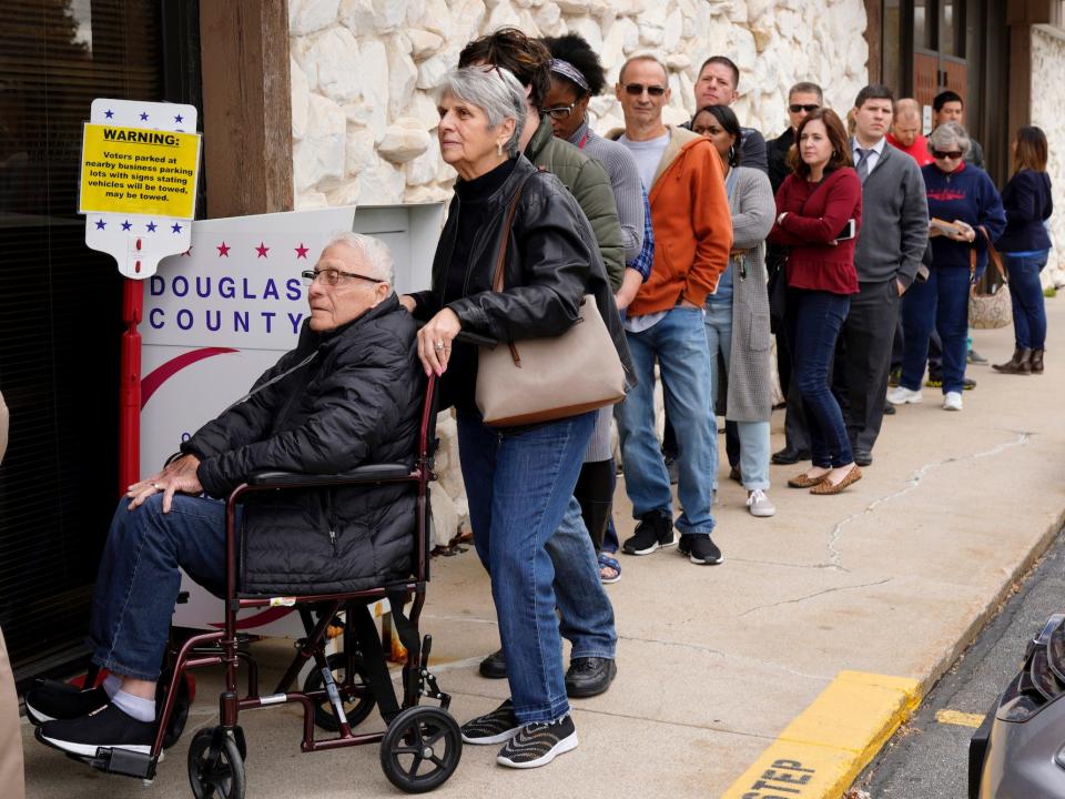 Early voters and those requesting absentee ballots line up outside the Douglas County Election Commision's offices in Omaha, Nebraska.