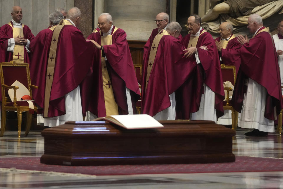 Cardinals and bishops offer signs of peace during the funeral ceremony of Australian Cardinal George Pell in St. Peter's Basilica at the Vatican, Saturday Jan. 14, 2023. Cardinal Pell died on Tuesday at a Rome hospital of heart complications following hip surgery. He was 81. (AP Photo/Gregorio Borgia)