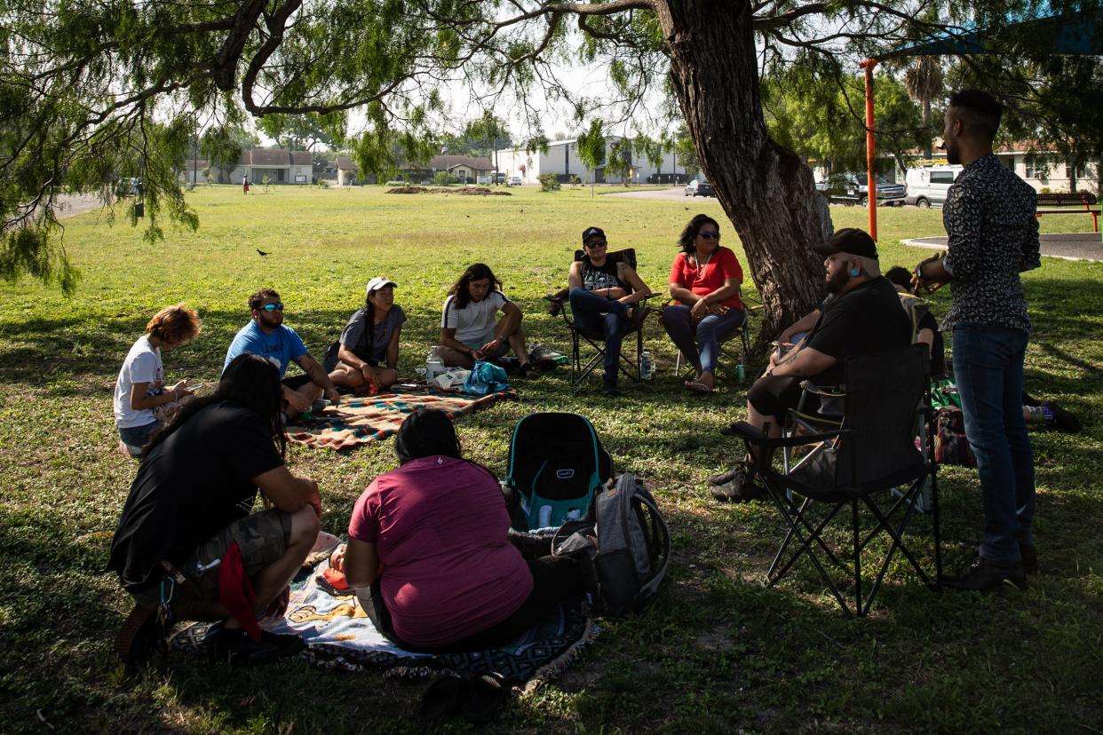 Members of Indigenous Peoples of the Coastal Bend, an intertribal group, sit under a shade tree at Carroll Lane Park and hold a quarterly meeting on April 15, 2023, in Corpus Christi, Texas.