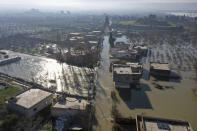 An aerial view of the al-Tlul village flooded after a devastating earthquake destroyed a river dam in the town of Salqeen near the Turkish border, Idlib province, Syria, Thursday, Feb. 9, 2023. (AP Photo/Ghaith Alsayed)