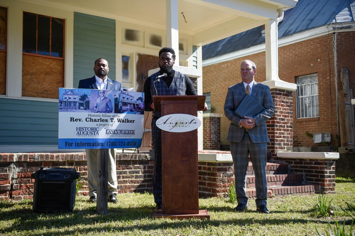 Hawthorne Welcher (center), director of Augusta Housing and Community Development, takes questions as Commissioner for District One Jordan Johnson (left) and President of Historic Augusta Inc. George Bush (right) stand behind after the City of Augusta's acquisition ceremony for the Rev. Charles T. Walker house off Laney Walker Boulevard on Wednesday, March 15, 2023.