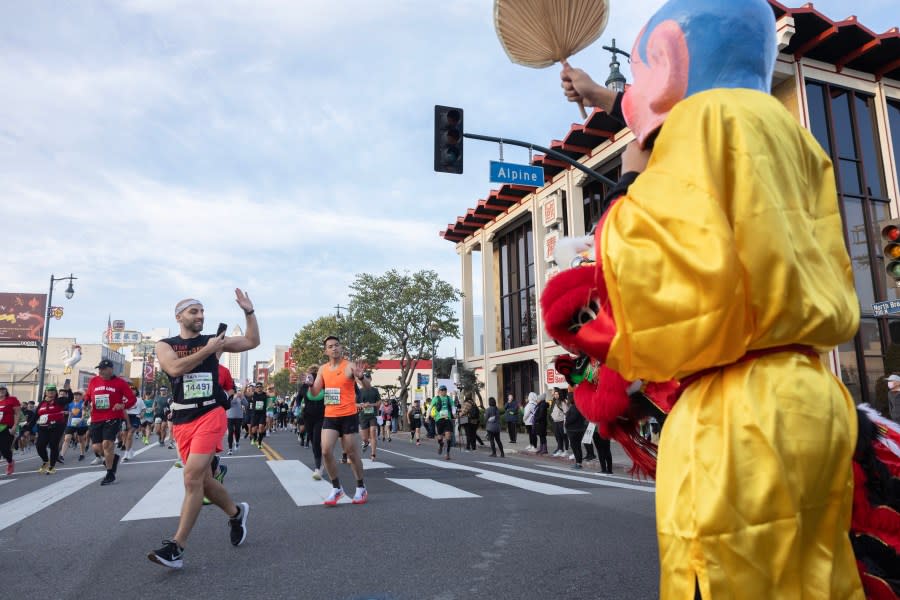 LOS ANGELES, CA MARCH 17: Dancers greet runners in Chinatown on Sunday, March 17, 2024. Over 25,000 runners competed in this year’s LA Marathon. (Myung J. Chun / Los Angeles Times via Getty Images)