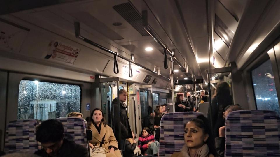 Passengers wait inside a train stuck on the Elizabeth Line (via REUTERS)