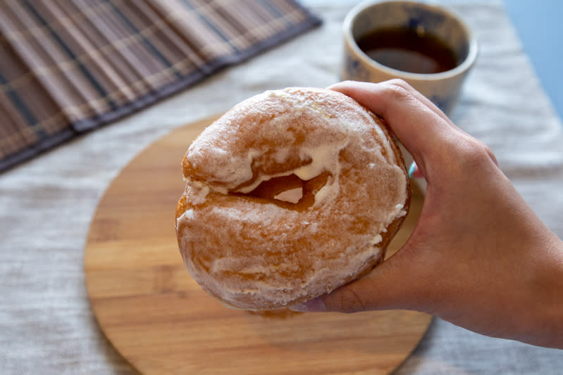 Hand holding Yuzu Citrus doughnut 