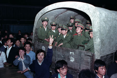 FILE PHOTO: Residents of Beijing, China, surround an army convoy of 4,000 soldiers May 20, 1989 in a suburb of the city to prevent them from continuing to Tiananmen Square, where the pro-democracy students are. REUTERS/Ed Nachtrieb/Files