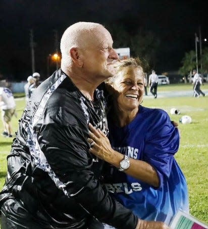 Dale Caparaso, left, and his wife Anne were left unscathed by Hurricane Ian, but Anne has been busy at her school, which is being used as a shelter.