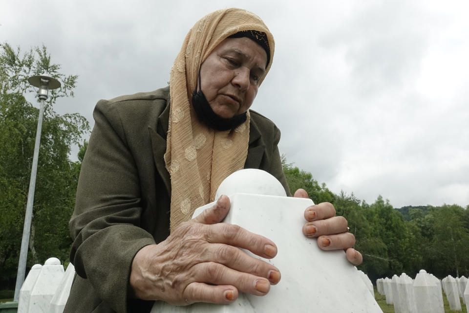 Bida Osmanovic, who lost her son and her mother in Srebrenica massacre, prays at the memorial cemetery in Potocari near Srebrenica, Bosnia, Friday, May 28, 2021. U.N. judges on Tuesday, June 8 deliver their final ruling on the conviction of former Bosnian Serb army chief Radko Mladic on charges of genocide, war crimes and crimes against humanity during Bosnia’s 1992-95 ethnic carnage. Nearly three decades after the end of Europe’s worst conflict since World War II that killed more than 100,000 people, a U.N. court is set to close the case of the Bosnian War’s most notorious figure. (AP Photo/Eldar Emric)