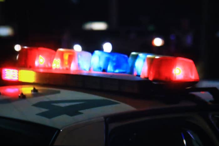 Close-up of a police car's flashing red and blue lights at night