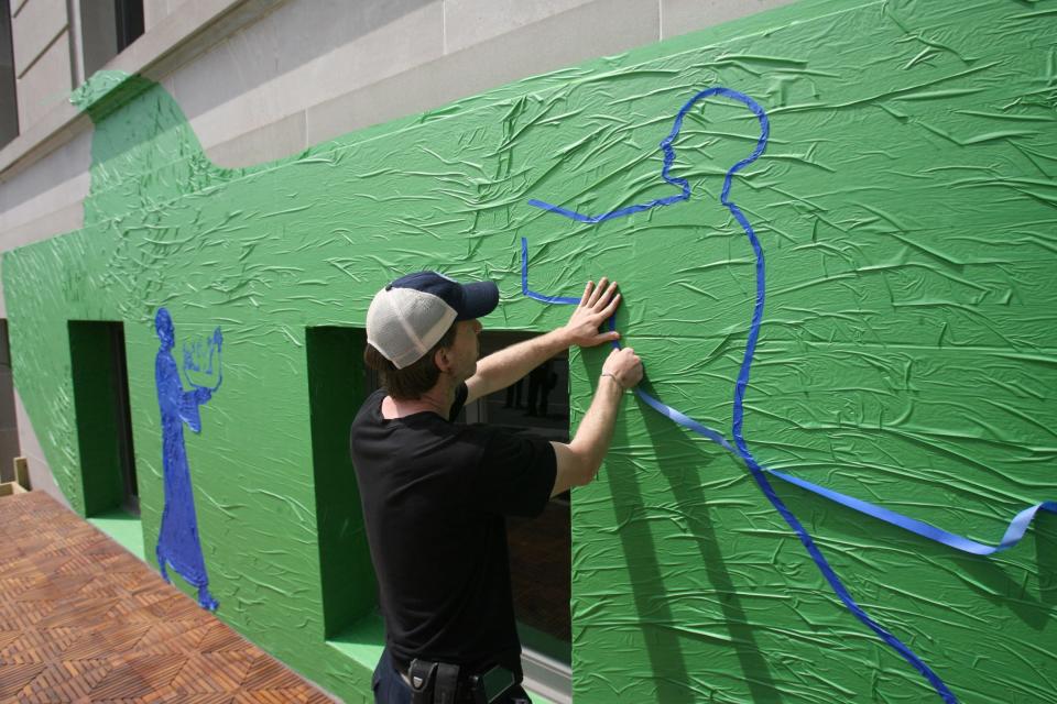 Michael Townsend works on one of his painters tape murals in 2012 at the Renaissance Providence Downtown Hotel.