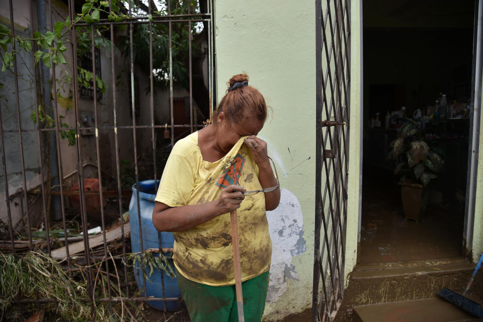 <p>Gloria Lynn cries next to a salon that was flooded after the rains related to the passage of Hurricane Maria, in Toa Baja, Puerto Rico, on Sept. 22, 2017.(Photo: Hector Retamal/AFP/Getty Images) </p>